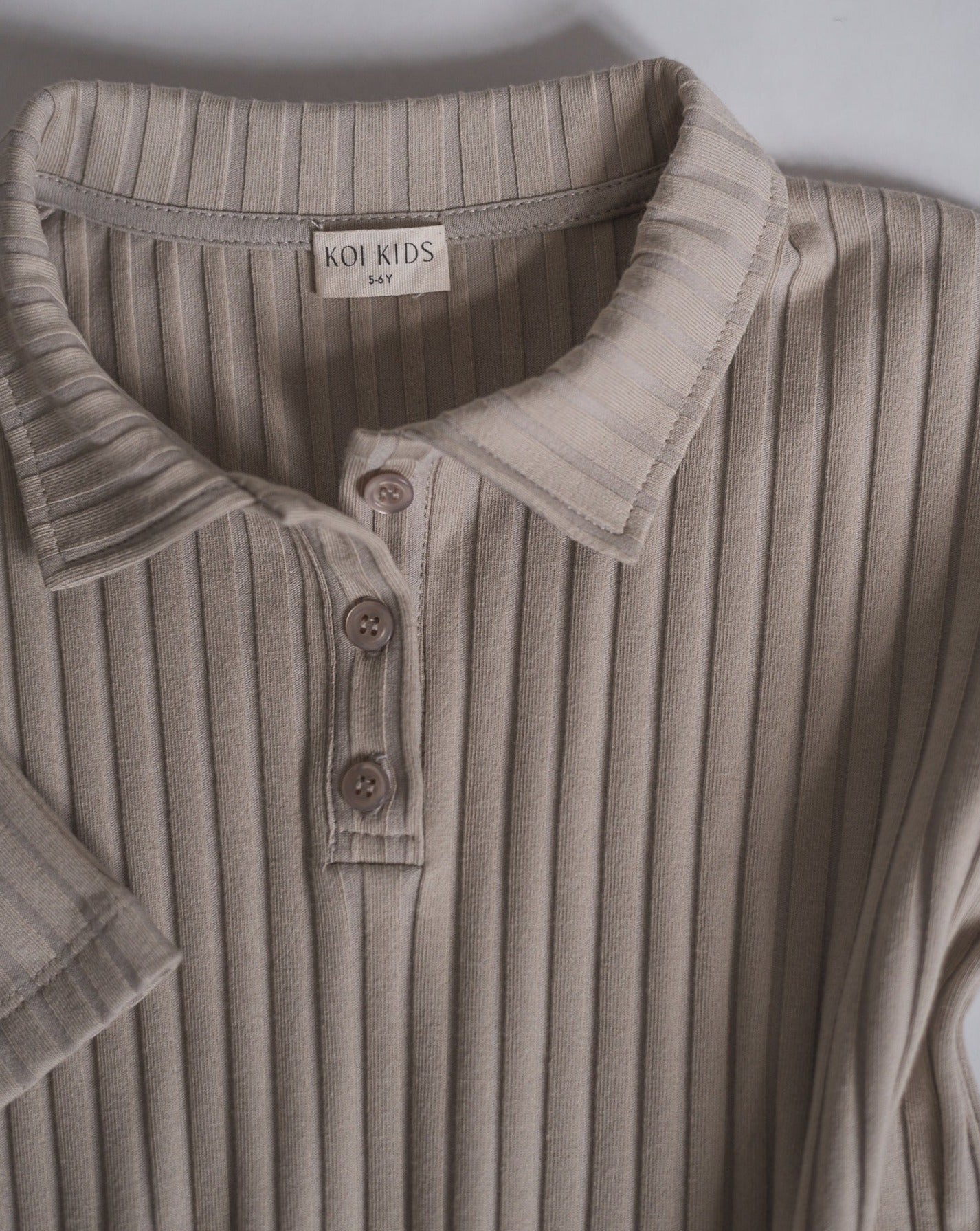 Close up of collar placket, beige dress.