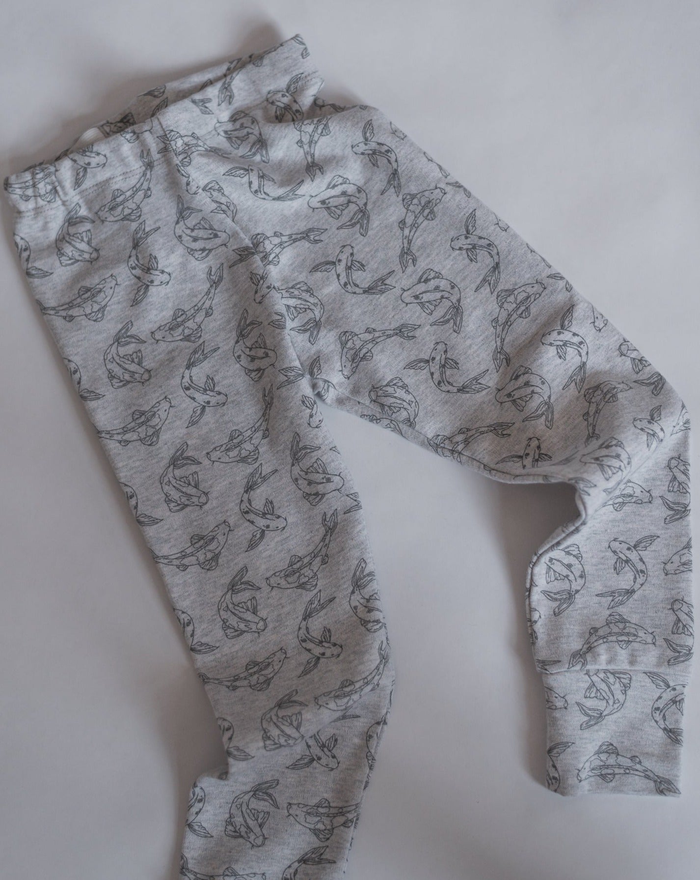 Leggings made from 100% GOTS certified organic cotton covered in our Koi fish allover print. Our leggings are designed with a soft elastic adjustable waist, foldable cuffs at the bottom of the legs.