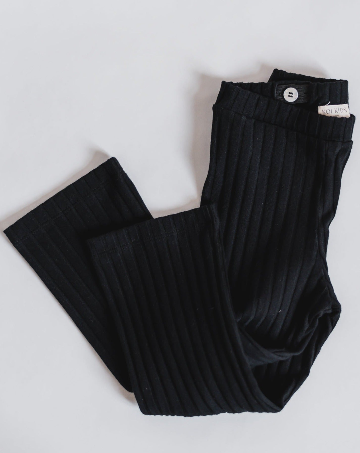 Black ribbed leggings with a wide leg and adjustable waist.