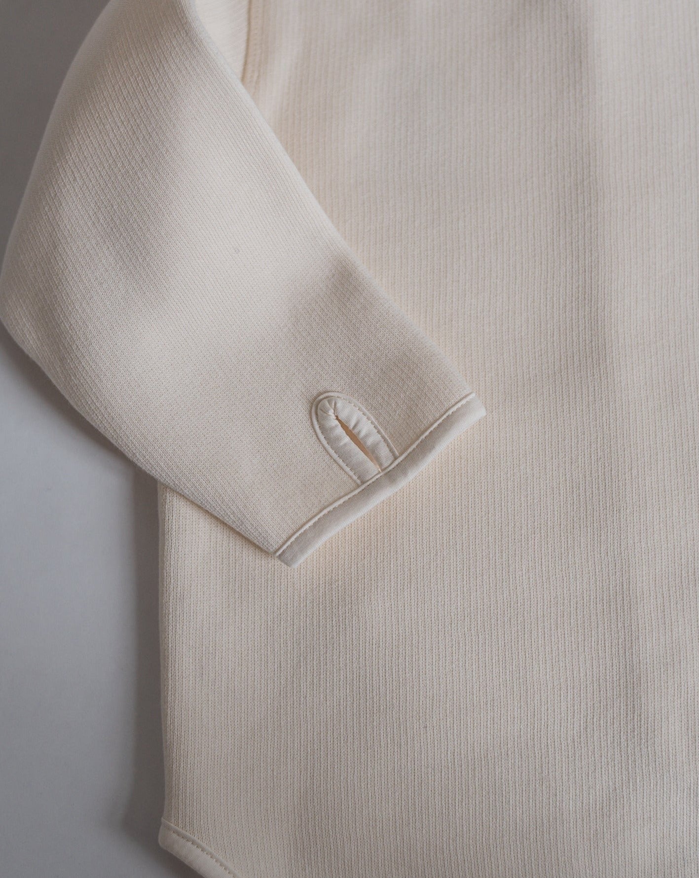 Offwhite jersey jacket, sleeves with thumb holes.