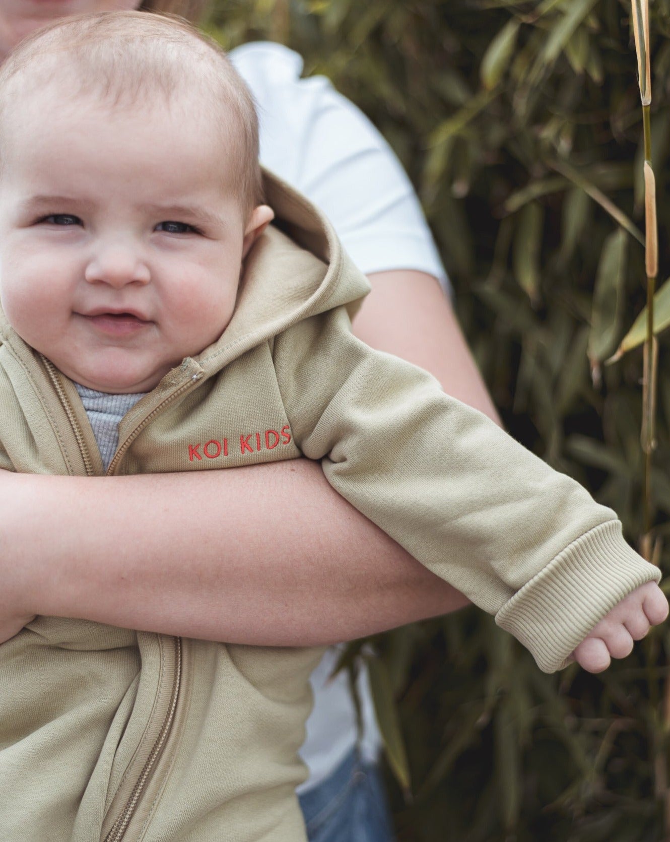Beige overall with zipper and hoodie. Made of the softest brushed organic cotton jersey.
