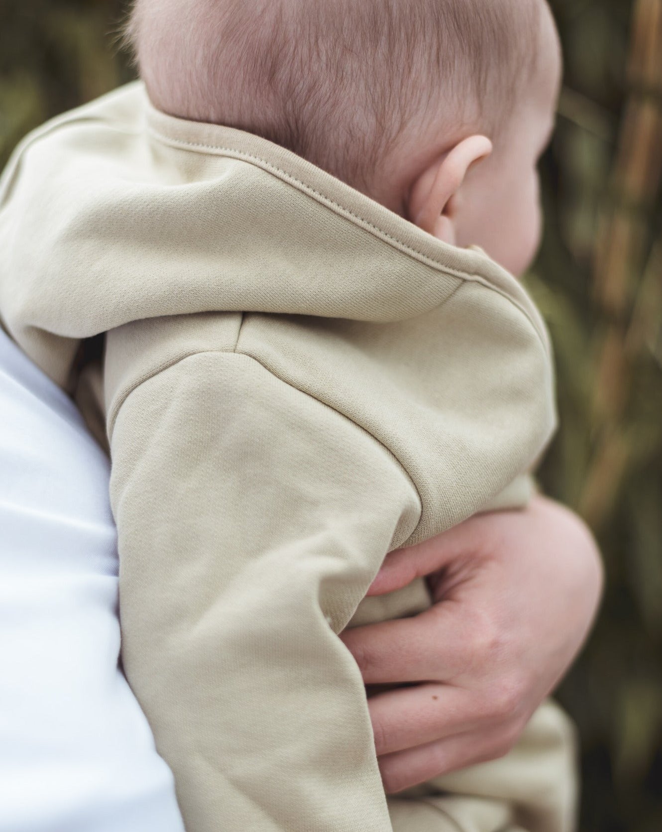 Beige overall with zipper and hoodie. Made of the softest brushed organic cotton jersey.