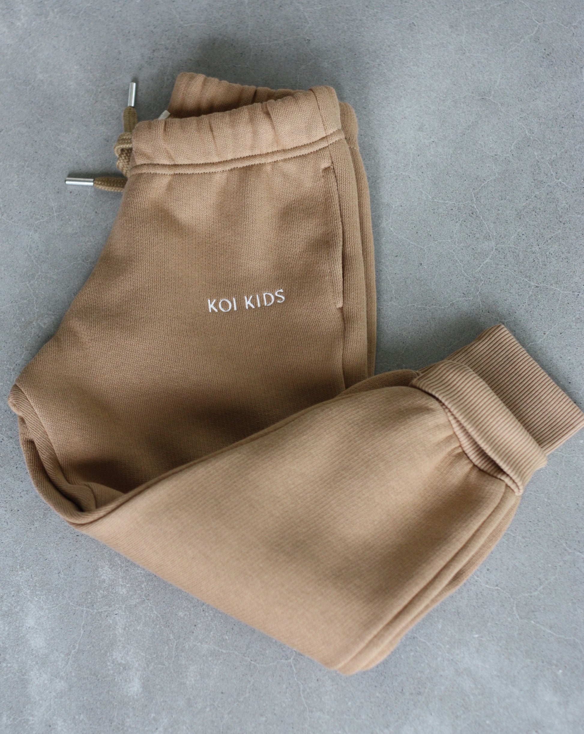 Camel colored sweatpants with a drawstring elasticated waist, offwhite logo embroidery, side pockets and ribbed cuffs.
